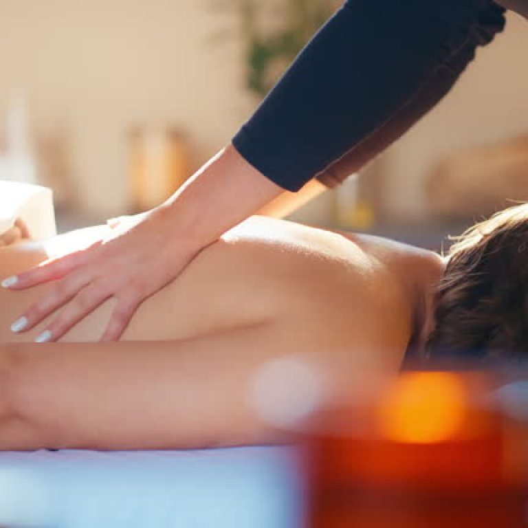 Hands, woman and back massage at spa for health, holistic wellness and relax at luxury hotel. Masseuse, body care and therapist with deep tissue treatment for pain relief, peace and healing skin